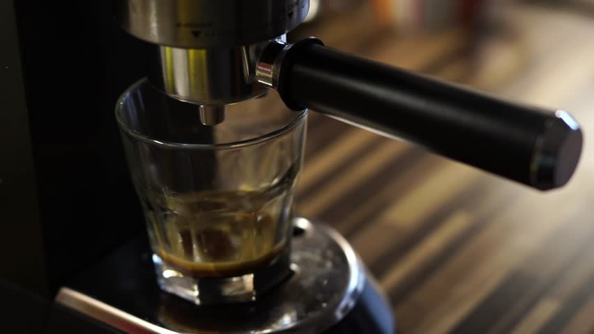 Coffee machine prepares coffee by dripping into a glass | Shutterstock HD Video #1101764543