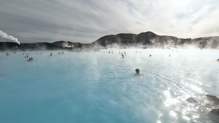 Iceland. Blue Lagoon. Geothermal spa. People relaxing in hot spring pool on Iceland. A lot of people enjoying bathing in a blue water lagoon Icelandic tourist attraction. Royalty-Free Stock Footage #1101768767