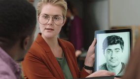 Woman, engineering or tablet presentation in facial recognition website, company about us or ai innovation for virtual reality or nft art. Graphic designer, man or collaboration on meeting technology - Powered by Shutterstock - Get 15% off with code: PIKWIZARD15