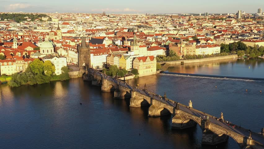 Prague Old Town in Czech Republic with Famous Sightseeing Places in Background. Charles Bridge Iconic 14th century Structure with View, Vltava river and Prague Cityscape. Must Visit City. Drone, 4k