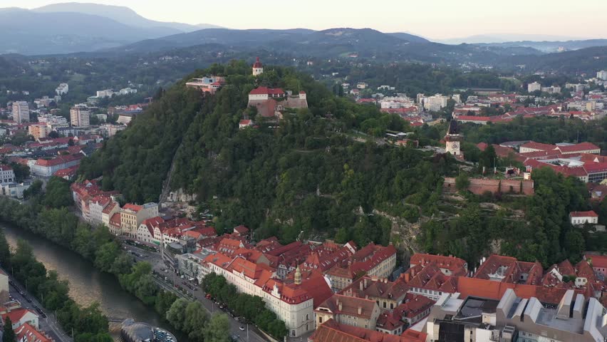 Graz Cityscape in Austria. Graz is the capital city of the southern Austrian province of Styria. At its heart is Hauptplatz, the medieval old town’s main square. Beautiful Sunset Light. Drone, 4k