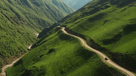 Aerial view of mountain serpentine road with moving car. Road in the Caucasus mountains leading to Juta in Georgia country. Video Stok
