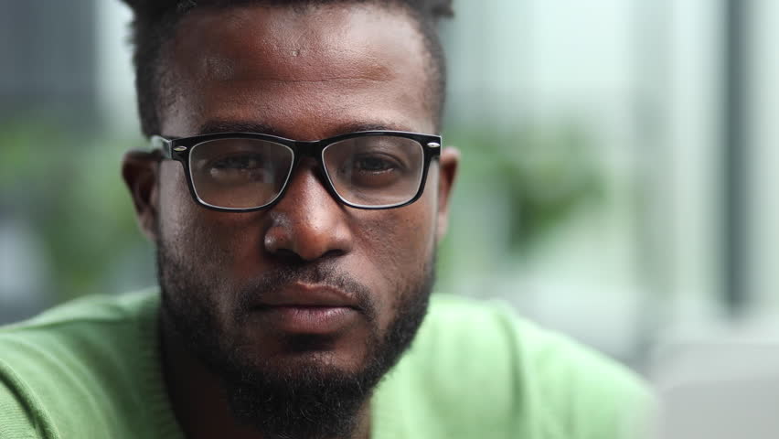 Portrait of a handsome man standing in the office and looking at the camera.