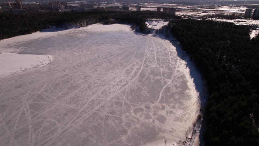Frozen forest lake from a bird