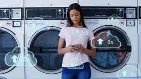 Cloud upload icons floating against african american woman woman using smartphone at laundromat shop. global networking and cloud storage technology concept - Powered by Shutterstock - Get 15% off with code: PIKWIZARD15