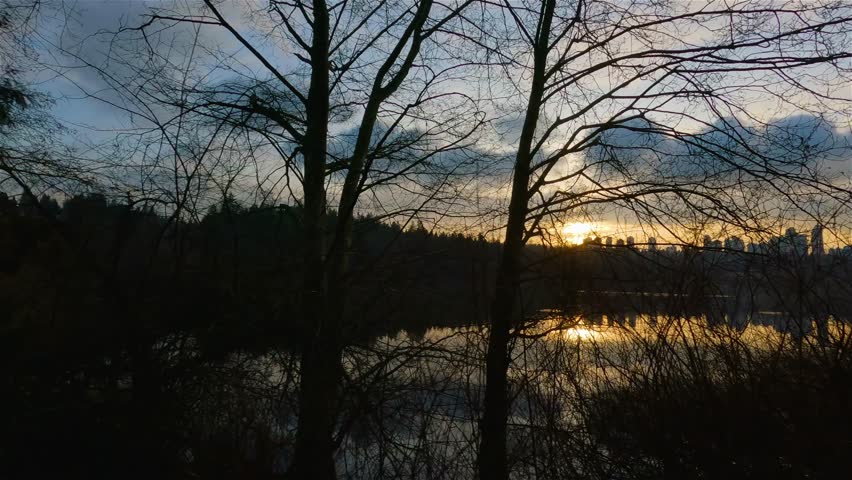 Trail by Peaceful Lake in the modern city, Deer Lake Park. Burnaby, Vancouver, BC, Canada. Colorful Winter Sunset Sky. Slow Motion Cinematic Pan.