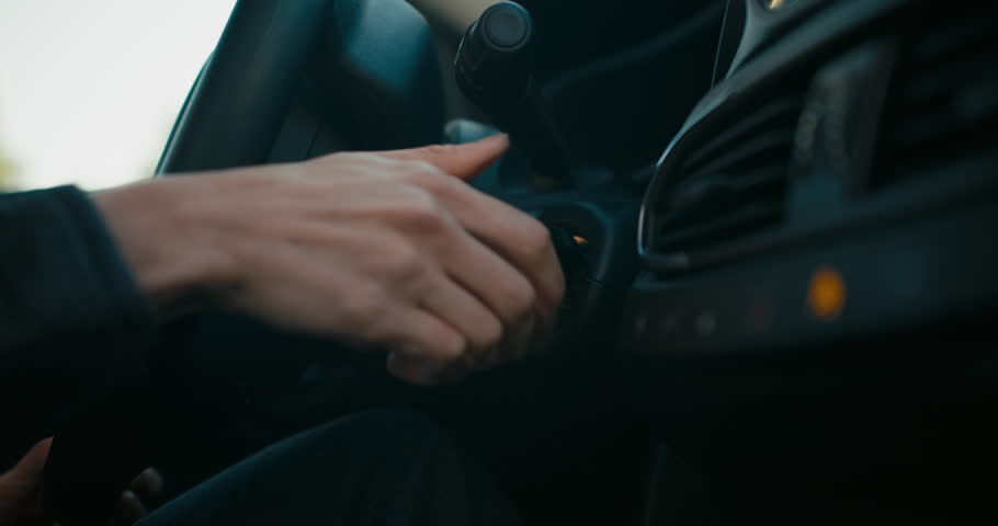 Woman inside the car hand holds the key in the ignition, start the car engine | Shutterstock HD Video #1101787255
