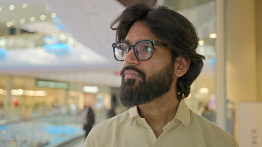 Arabian businessman Indian man worker company CEO corporate manager business executive male entrepreneur walking indoors in office corporation client guy buyer walk in shopping mall talking greeting