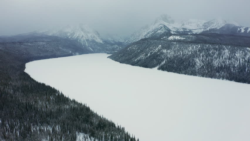 Aerial over frozen Redfish Lake in Sawtooth National Forest; Stanley Idaho