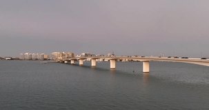 Evening aerial video of the Sarasota, Florida Skyline and Bridge Across Sarasota Bay	