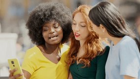 Three multiethnic women taking selfie in the street