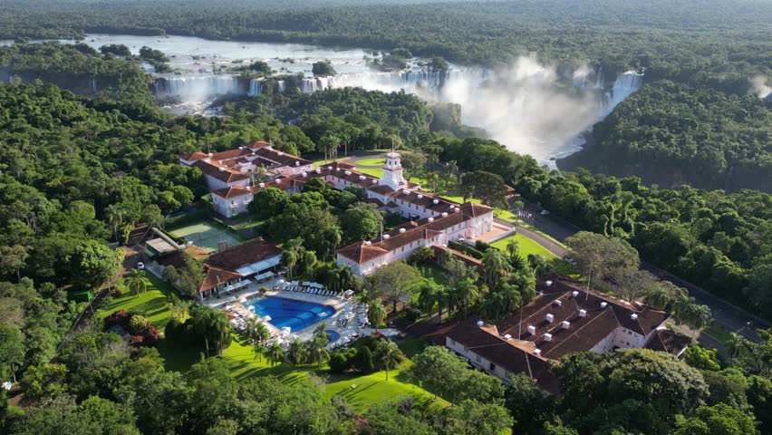 Beautiful aerial view to Iguazu Falls waterfalls and green rainforest in border of Brazil and Argentina