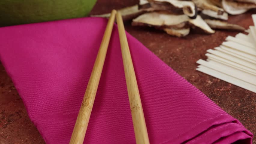 pile of dried shiitake mushrooms and raw chinese noodles, close-up, on a table