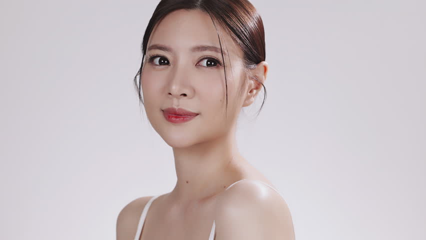 Close up portrait of beauty young Asian female face with healthy skin make up on white background.