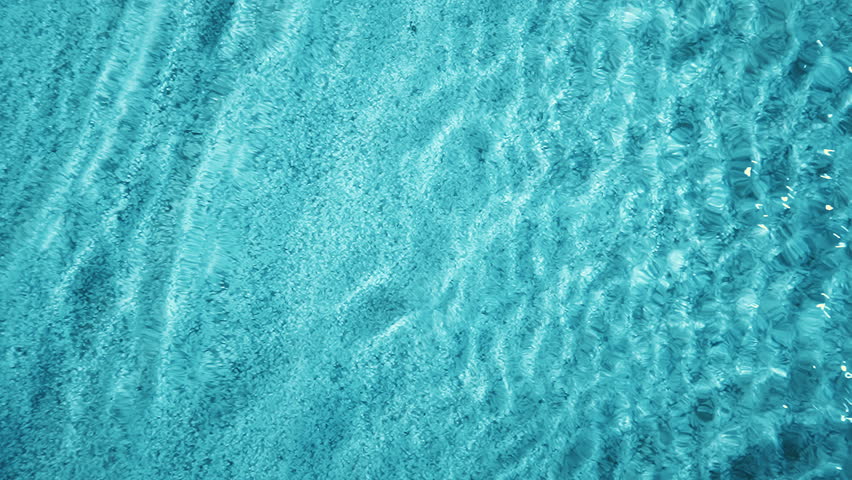Top down view seabed texture, sea floor beach sand ripple of water waves reflection. Blue turquoise sandy bottom surface summer background slow motion. Underwater seafloor close-up Royalty-Free Stock Footage #1101824971