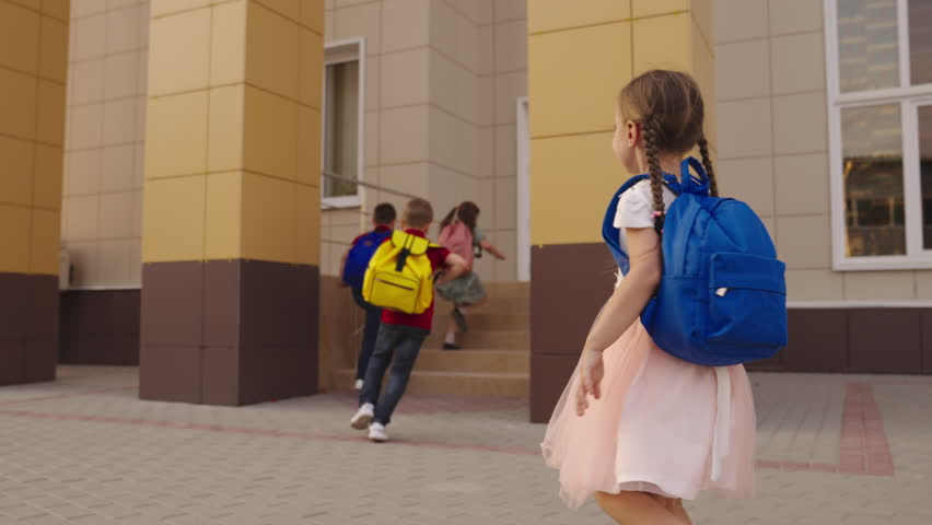 child boy girl run with school backpacks school. happy cheerful children playtime children's yard. kid child running school class for lesson. students first graders running smiling school bags backs. Royalty-Free Stock Footage #1101826521