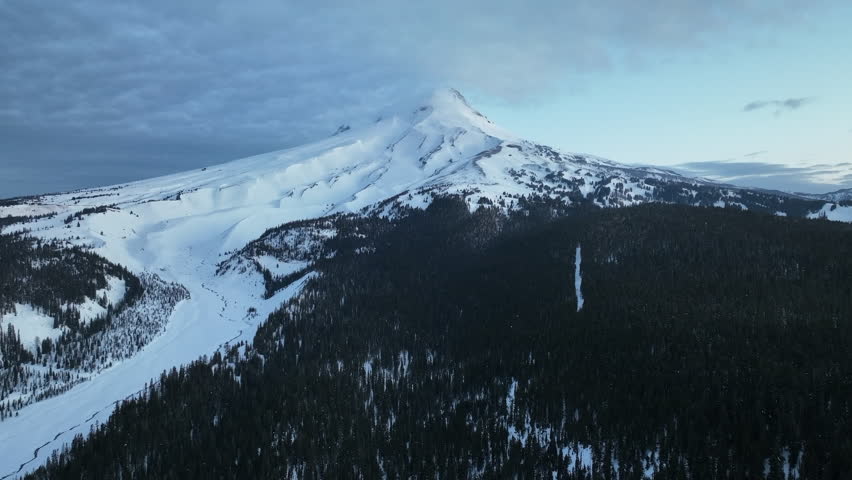 Snow covers Mt Hood, a beautiful stratovolcano found about 50 miles southeast of Portland, Oregon. Mt. Hood has one of the longest ski seasons in the U.S. due to its annual snow pack.