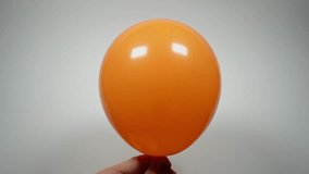 Orange balloon become smaller helium party ball