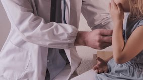 male doctor pediatrician with gadget in professional medical uniform examining patient, uses stethoscope to examine health little patient, child 3 years old, health insurance, examination, treatment - Powered by Shutterstock - Get 15% off with code: PIKWIZARD15