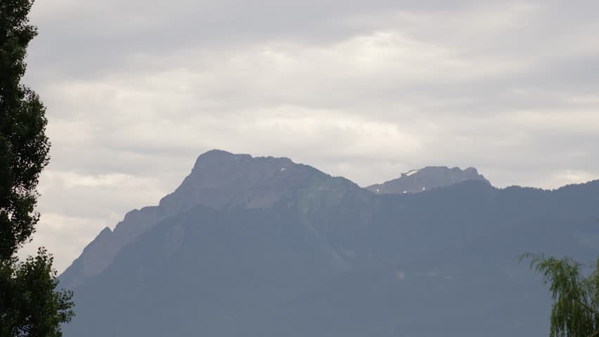 A time lapse of Mount Cheam in British Columbia Canada with clouds billowing overhead on a sunny day