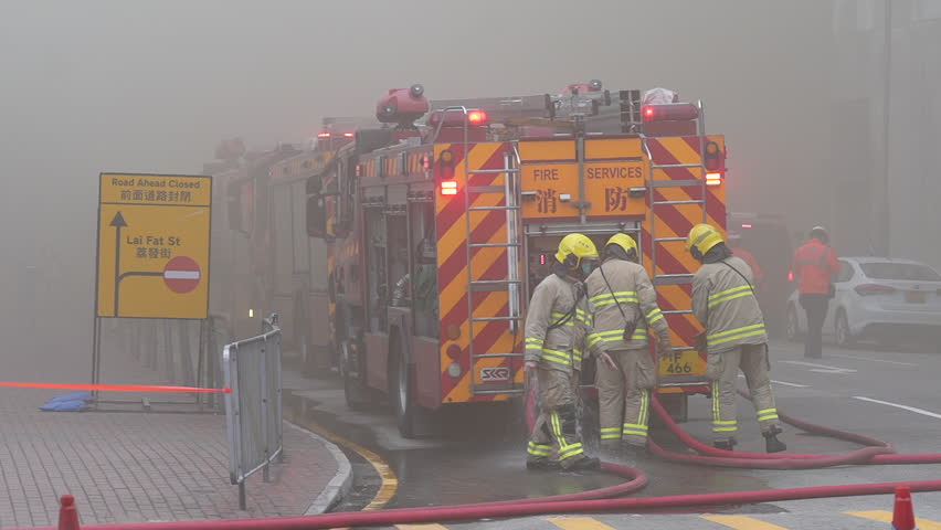 Hong Kong, China- March 27 2023:Firefighters doused the blaze amidst the smoke.
