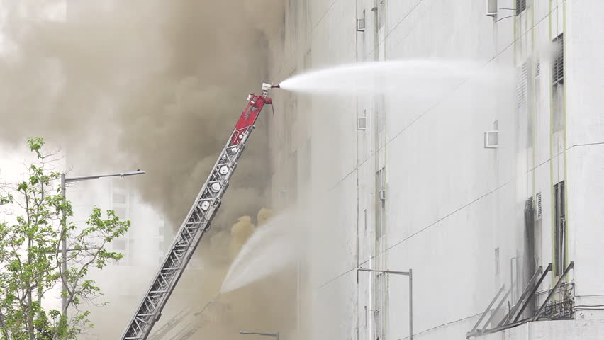 Hong Kong, China- March 27 2023:Firefighters doused the blaze amidst the smoke.