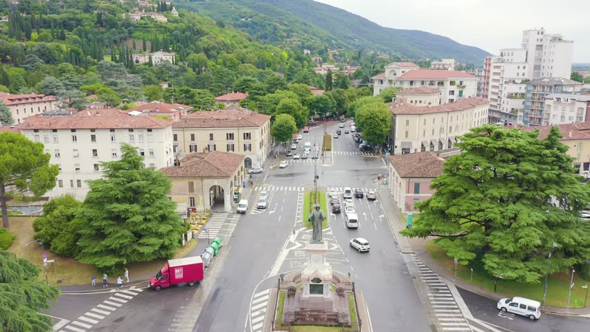 Inscription on video. Brescia, Italy. Monument to Arnaldo da Brescia. Arnaldo Square. Name is burning, Aerial View, Departure of the camera