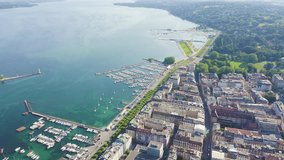 Inscription on video. Geneva, Switzerland. Flight over the central part of the city. Lake Geneva. Shimmers in colors purple, Aerial View