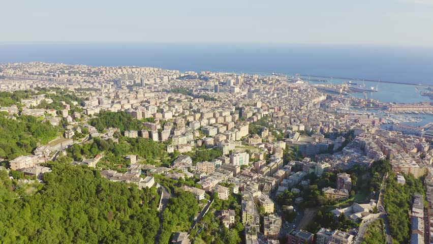 Inscription on video. Genoa, Italy. Central part of the city, aerial view. Ships in the port. Multicolored text appears and disappears, Aerial View