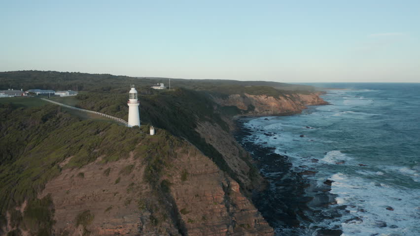 An aerial top down sunset shot of Cape Otway lighthouse, along the coastline, Abollo Bay, Australia