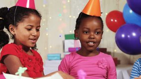 Animation of confetti falling over diverse children with party hats at birthday party. party, childhood and celebration concept digitally generated video. - Powered by Shutterstock - Get 15% off with code: PIKWIZARD15