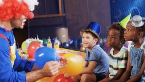 Animation of confetti falling over diverse children and clown at birthday party. party, childhood and celebration concept digitally generated video.