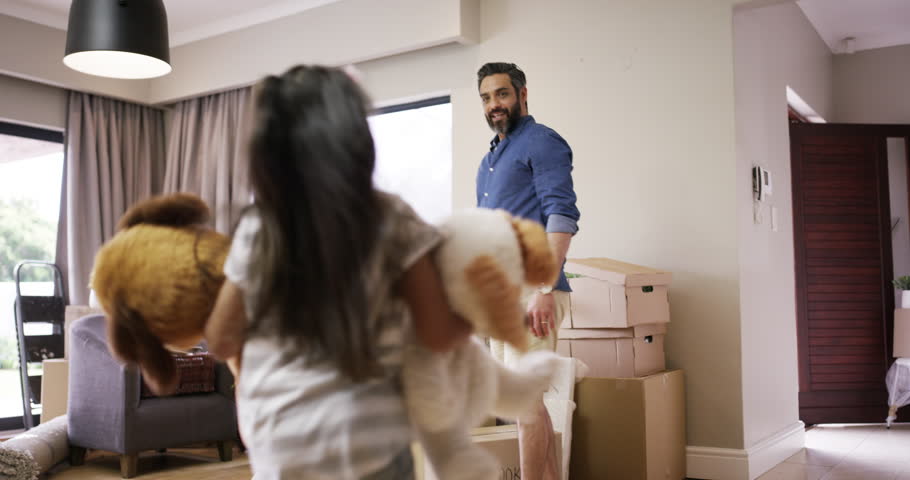 Happy people or family moving into new house with cardboard box. Excited girl smile in a new home, house or apartment. Parent and kid with teddy bear toy in new interior of purchased property Royalty-Free Stock Footage #1101836677