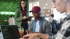 Computer coding, men or women collaboration on laptop or tablet in design startup. Smile, happy people or teamwork website engineer with cyber security code, digital software or technology app office - Powered by Shutterstock - Get 15% off with code: PIKWIZARD15