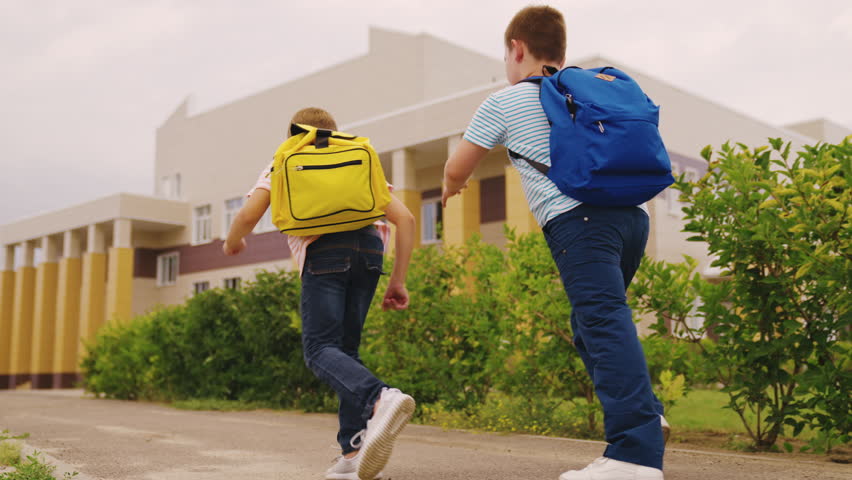 Child boys run lesson school. friends classmates with school backpacks run classroom lesson. school students recess run school yard. chidhood dream. classmate catches up with boy. child game. | Shutterstock HD Video #1101838209