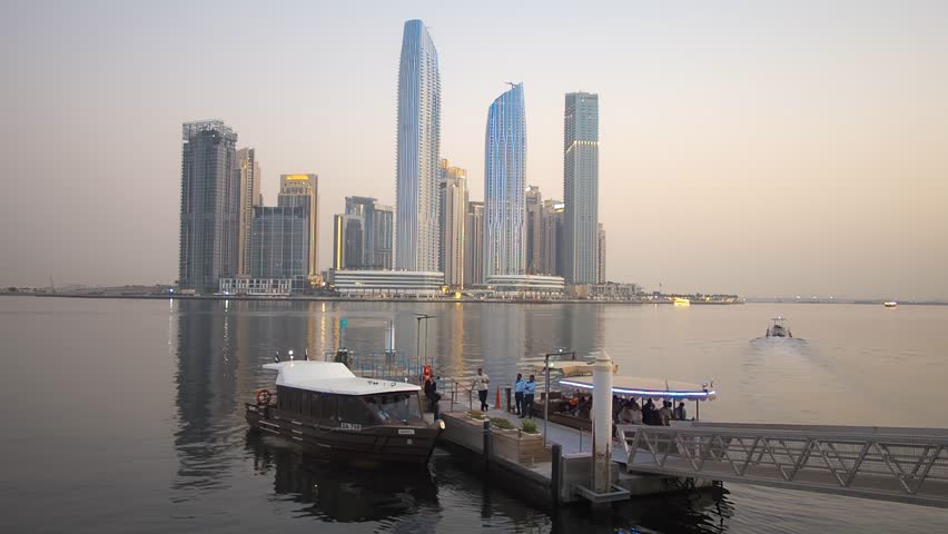 View of the Dubai Creek Marina harbor, departure of the boat with passengers from the boat station. Dubai, UAE