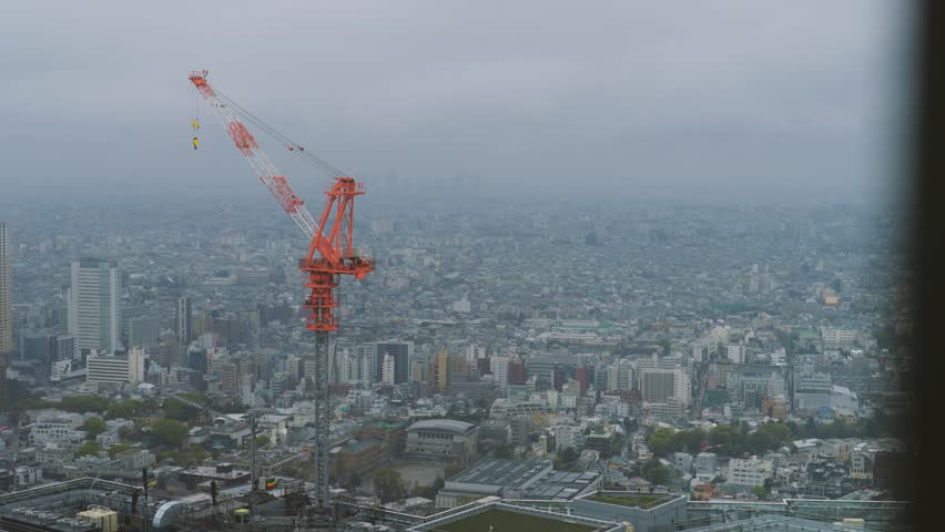 Landscape video of a tower crane on top of a high-rise building | Shutterstock HD Video #1101843075