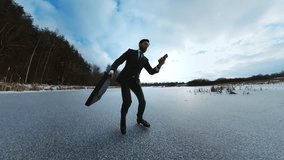 Shot from below of handsome bearded man late for meeting. Businessman ice skating while calling on smartphone on way to business center. Lack of transport. Village. Winter forest on background - Powered by Shutterstock - Get 15% off with code: PIKWIZARD15