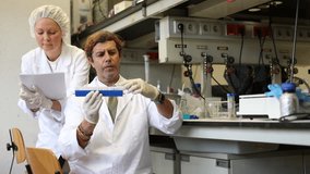 Confident woman and man technical experts provide analysis services in research laboratory and record observations of experiment - Powered by Shutterstock - Get 15% off with code: PIKWIZARD15