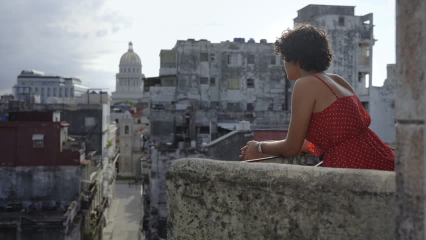 Young Latin American woman contemplating Havana city from balcony At Home in Cuba Royalty-Free Stock Footage #1101846813