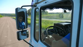 Trucker in sunglasses reflecting in side mirror of moving car. Man driving lorry riding to destination through countryside road. Cargo transportation concept. Beautiful background. Slow mo Close up - Powered by Shutterstock - Get 15% off with code: PIKWIZARD15