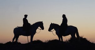 Man and Woman on a Camargue or Camarguais Horse in the Dunes at Sunrise, Manadier in the Camargue in the South East of France, Les Saintes Maries de la Mer, Real Time 4K