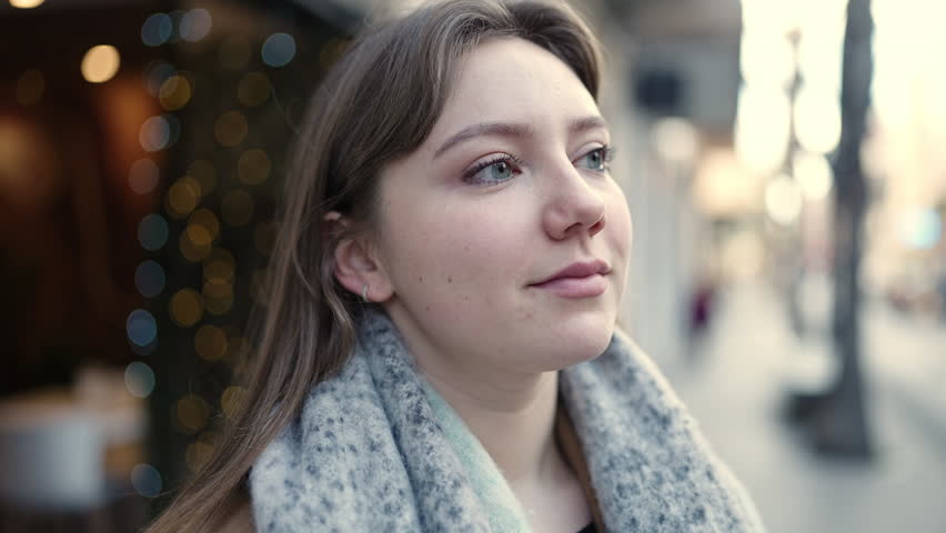 Young blonde woman looking to the side with relaxed expression at street | Shutterstock HD Video #1101850743
