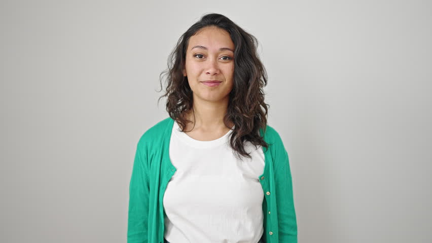 Young beautiful hispanic woman smiling confident doing strong gesture with arms over isolated white background | Shutterstock HD Video #1101850893