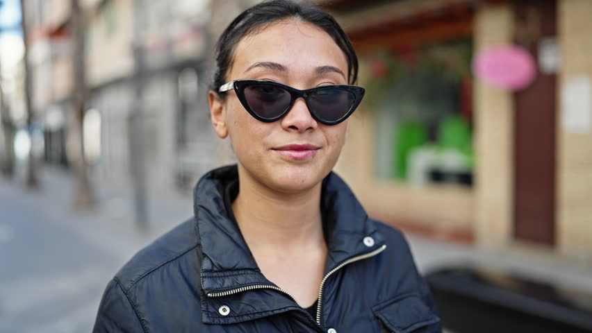 Young beautiful hispanic woman smiling confident standing at street | Shutterstock HD Video #1101850917