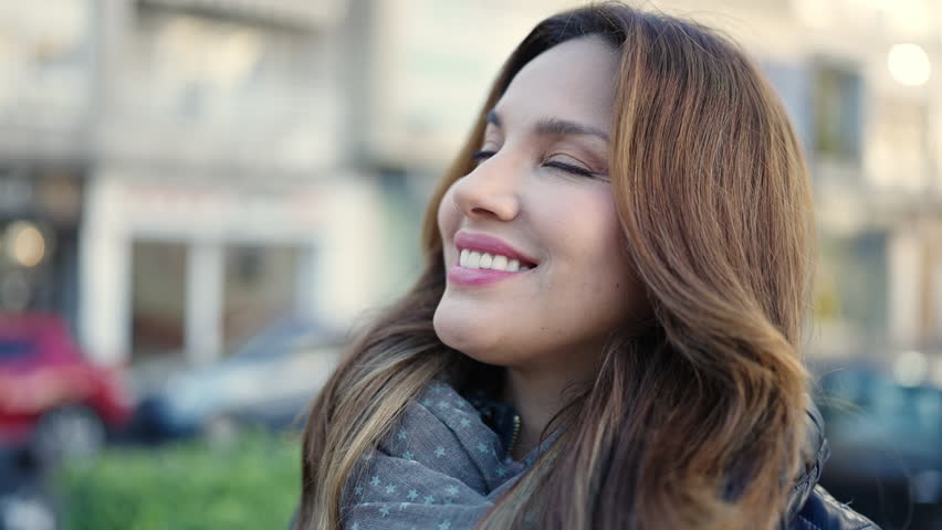 Young beautiful hispanic woman smiling confident standing at street | Shutterstock HD Video #1101850981