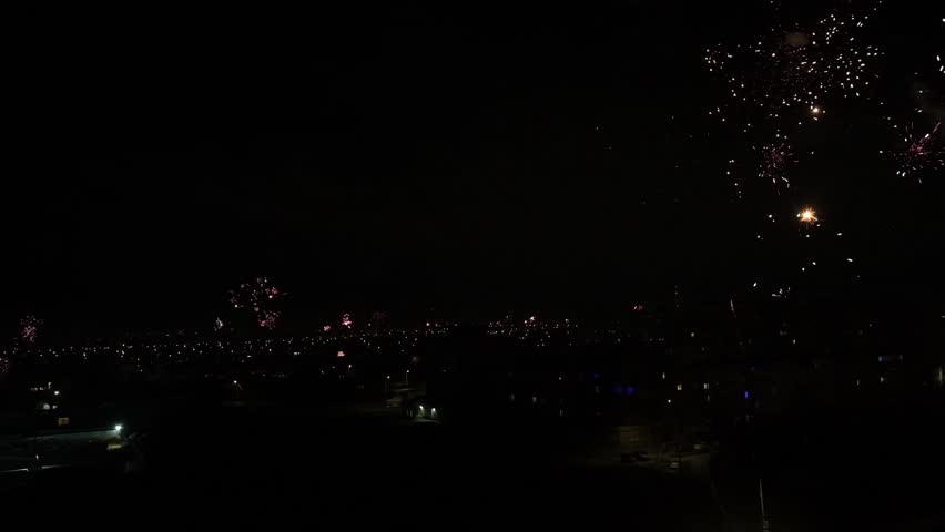 Home fireworks all over the city in celebration of the New Year. Lots of fireworks from private houses. Residents of the city launch fireworks.
