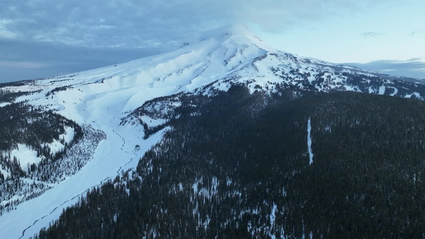 Snow covers Mt Hood, a beautiful stratovolcano found about 50 miles southeast of Portland, Oregon. Mt Hood has one of the longest ski seasons in the U.S. due to its annual snow pack.