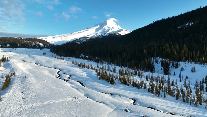 Early morning light shines on Mt Hood, an iconic stratovolcano found about 50 miles southeast of Portland, Oregon. Mt Hood has one of the longest ski seasons in the U.S. due to its annual snow pack.