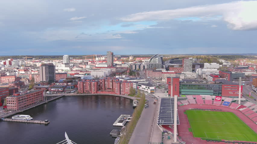 Tampere, Finland: Aerial view of Nordic city in spring, dark waters of adjacent lake - landscape panorama of Northern Europe from above